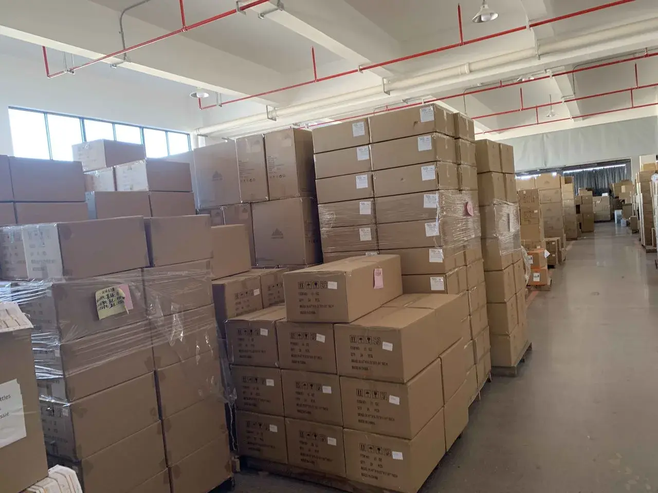 Labeled export cartons staged in a warehouse before an Amazon FBA packaging and labeling inspection.
