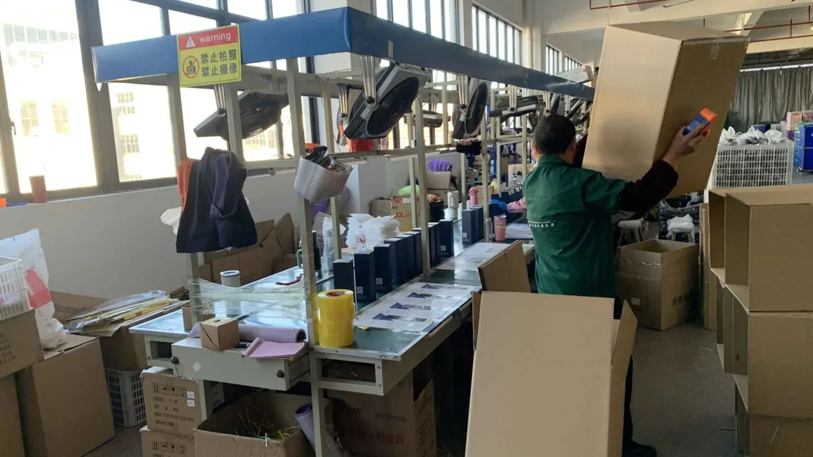 Factory packing area where packaging, labels, and carton preparation are checked before shipment.