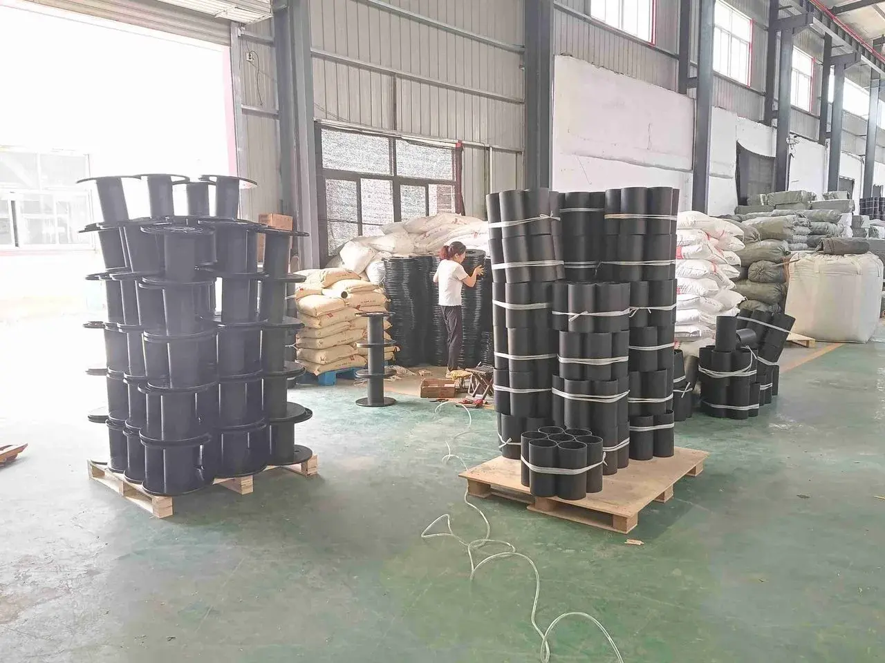 Factory floor with staged material reels reviewed during an on-site quality visit.