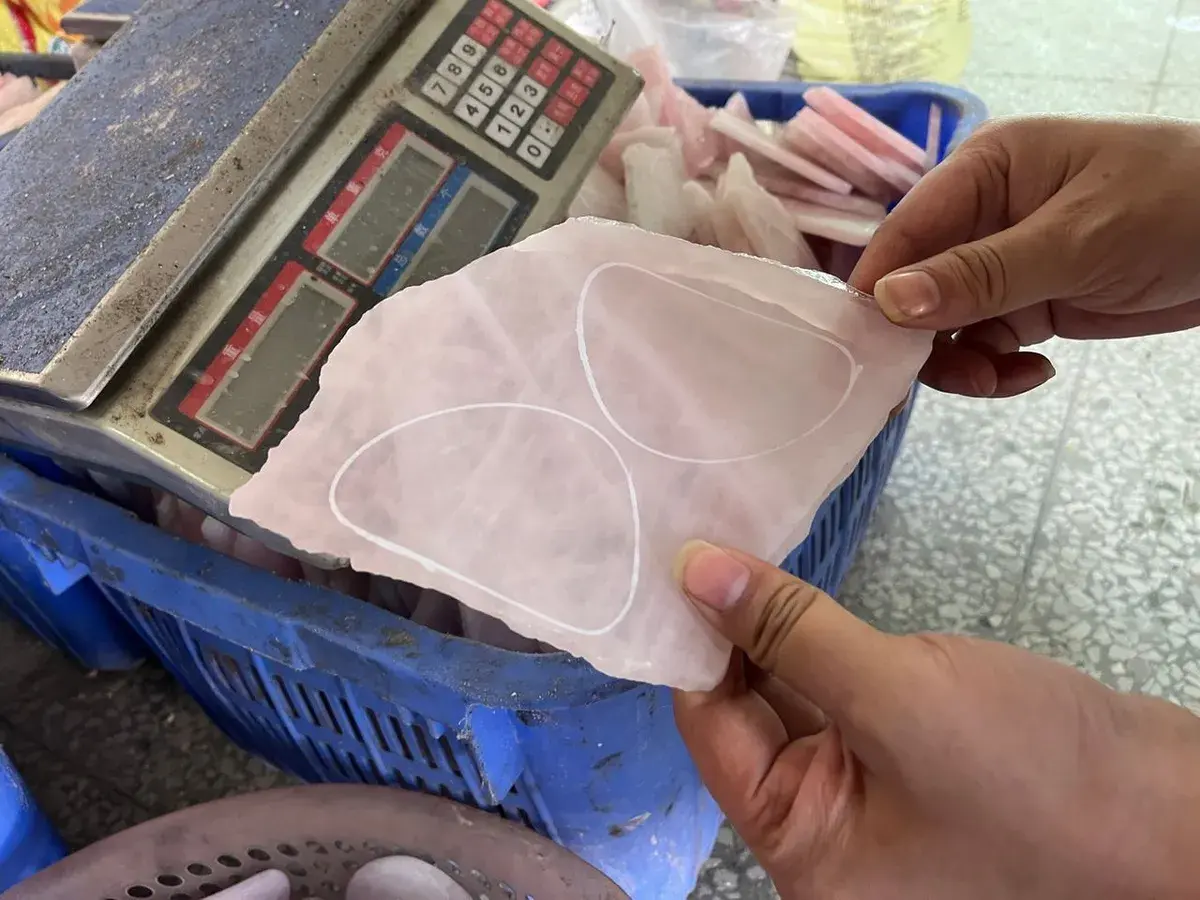 Inspector checking an in-process textile component against a measurement reference.