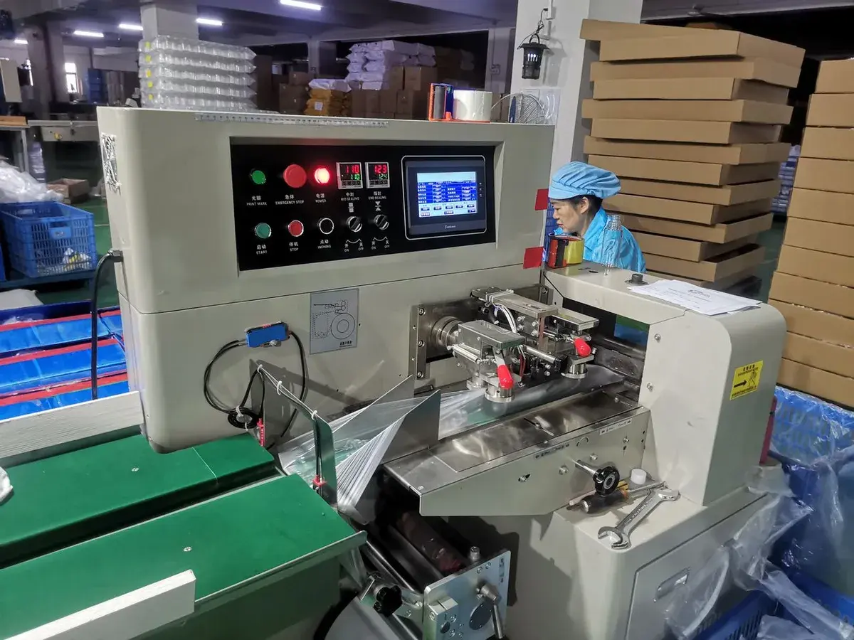 Operator monitoring an active production machine during an in-process factory check.