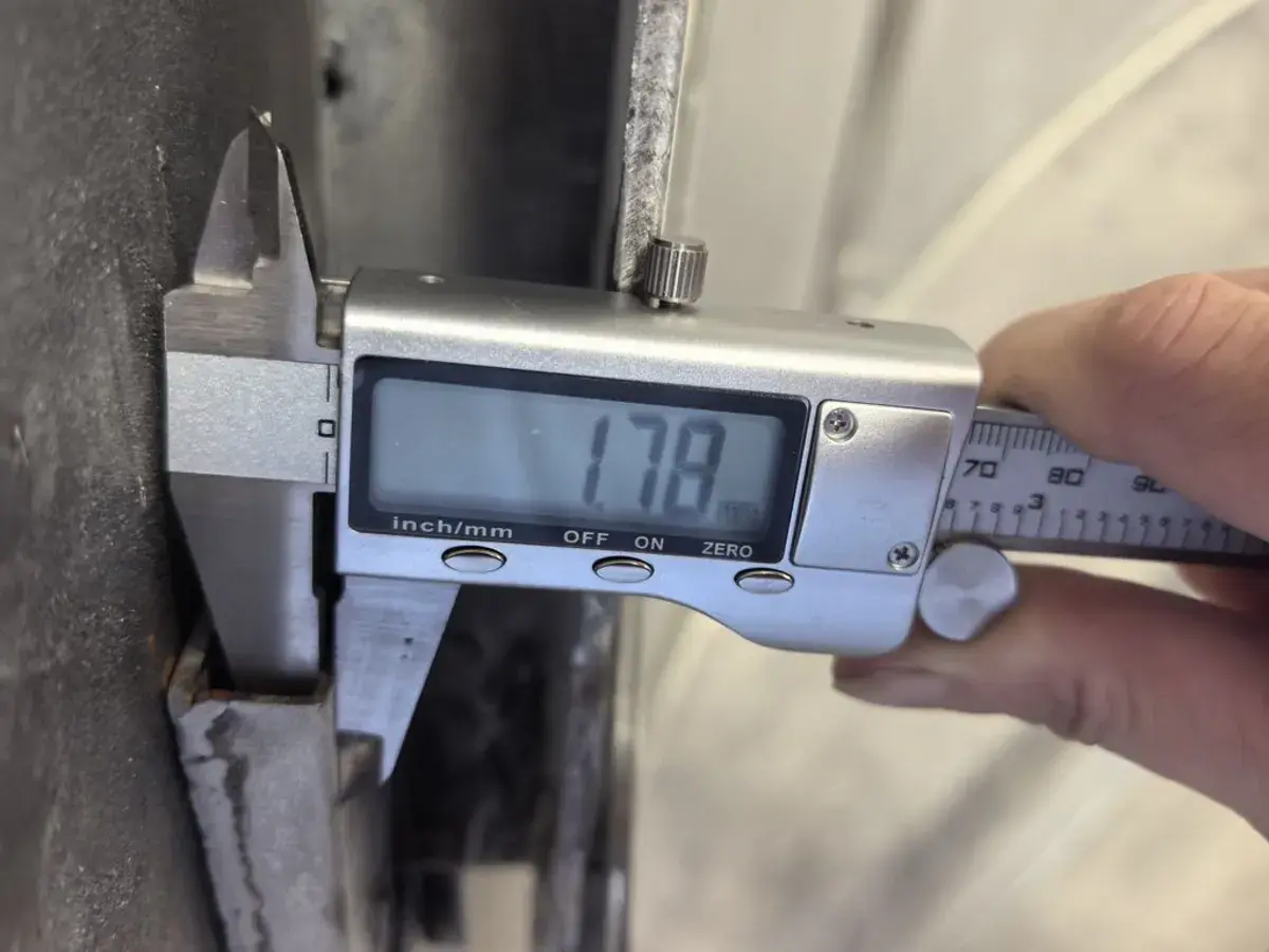 Inspector measuring a product dimension with a digital caliper.
